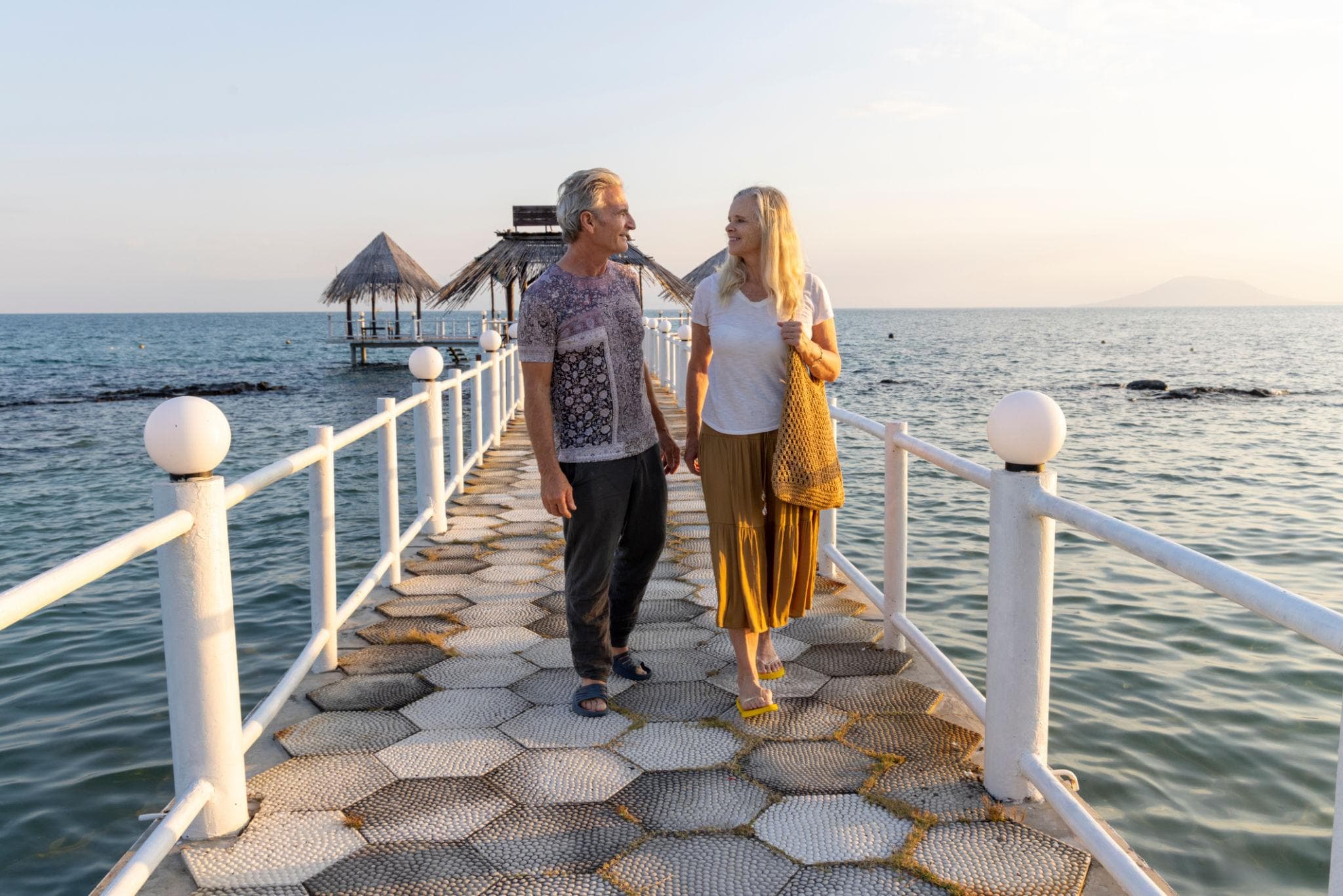 Couple on a seaside pier at sunset