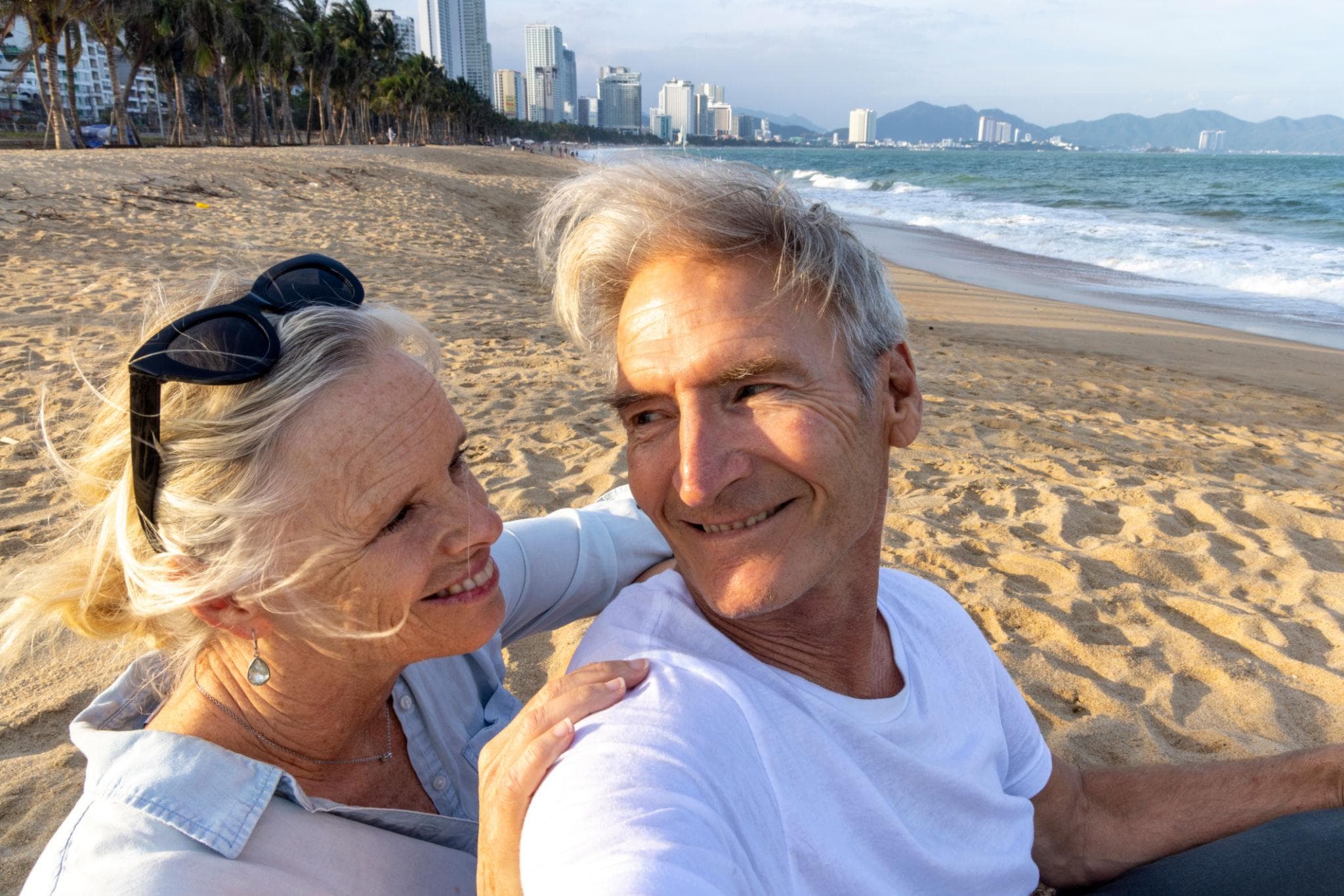 Couple on the beach by the Da Nang skyline