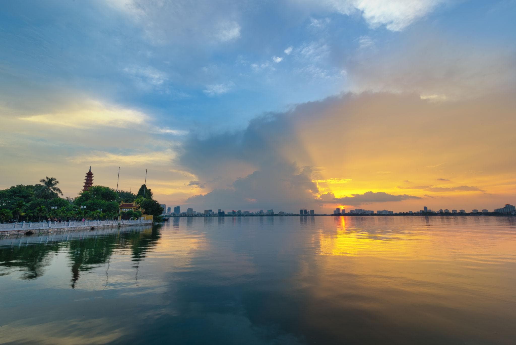 A scenic lake and pagoda in Vietnam at sunset